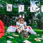 a little girl posing in an alice in wonderland themed photoshoot
